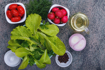 top view of a mixture of fresh leaves, vegetables and spices for making salad