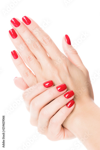 Cuadros en Lienzo Hands of a young woman with red manicure on nails