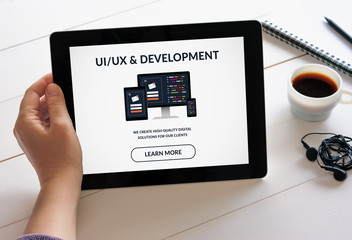 Wall Mural - hand holding tablet with ui/ux design and development concept on screen