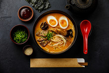 Ramen Asian Noodle In Broth With Beef Tongue Meat, Mushroom And Ajitama Pickled Egg In Bowl On Dark Background