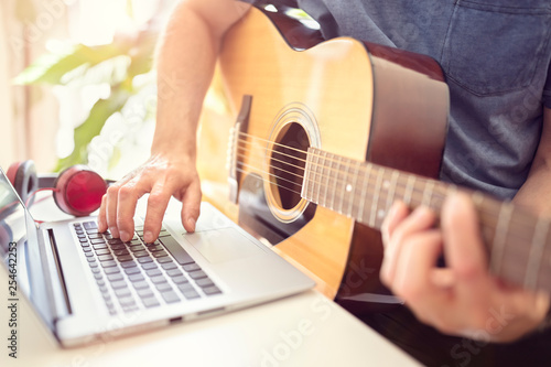 Cuadros en Lienzo Musician playing acoustic guitar and recording music on computer