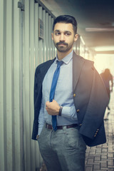 Wall Mural - Portrait of handsome businessman standing in building under construction area tunnel.