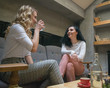 © Pavko - Two best girlfriends are talking and chatting at cafe