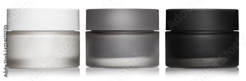 Cuadros en Lienzo Set of white, gray and black cosmetic cream jars, isolated on white background
