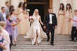 © Aleksandr - Beautiful couple go down the stairs. Wedding