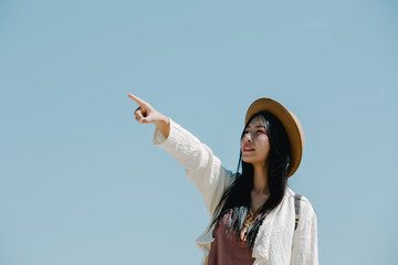 Wall Mural - Female tourists spread their arms and held their wings, smiling happily.