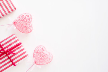 Two pink hearts and gift box on white background