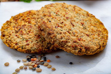 Tasty vegetarian food, raw burgers made from lentils legumes with vegetables ready for cooking