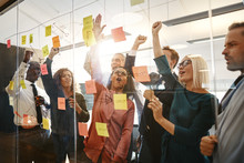Diverse Businesspeople Cheering During An Office Brainstorming S