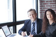 © yurolaitsalbert - business woman and business partner sitting behind a Desk