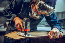 Carpenter Using Circular Saw For Cutting Wooden Boards. Construction Details Of Male Worker Or Handy Man With Power Tools