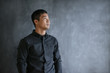 © mavoimages - Asian businessman thinking while standing in front of a chalkboard