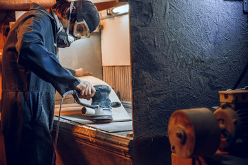 Wall Mural - Carpenter using circular saw for cutting wooden boards. Construction details of male worker or handy man with power tools