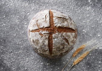 Wall Mural - Bakery background. Homemade bread on a black background viewed from above. Top view.