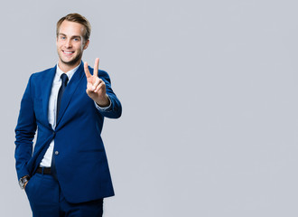 businessman showing two fingers or victory gesture