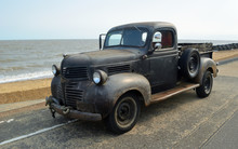  Rusty Classic Piick Up Truck  Parked On Seafront Promenade.