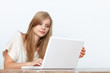 © gallofilm - Young woman using a notebook computer indoors