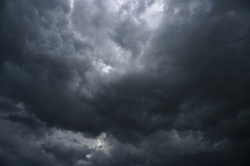 Wall Mural - Dark, grim, stormy, rainy sky with rays of light. Scary hurricane clouds. Natural element. Stock Photo for your design