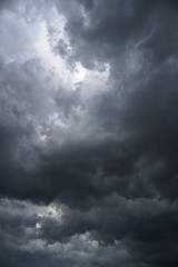 Wall Mural - dark, grim, stormy, rainy sky with rays of light. scary hurricane clouds. natural element. stock pho