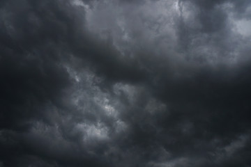 Wall Mural - dark, grim, stormy, rainy sky with rays of light. scary hurricane clouds. natural element. stock pho