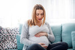 © leszekglasner - Young pregnant woman suffering from abdominal pain at home