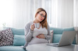 © leszekglasner - Pregnant woman working online with laptop at home, freelancing concept