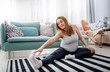 © leszekglasner - Beautiful pregnant woman doing exercise at home in living room, health during pregnancy