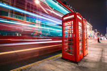 Light Trails Of A Double Decker Bus Next To The Iconic Telephone Booth In London