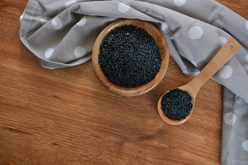 raw black lentils in a bowl