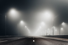 Foggy Misty Night Road Illuminated By Street Lights