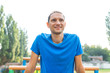 © Kristina Blokhin - Fit muscular man closeup of face smiling happy looking up doing calisthenics workout by horizontal bars parallel bars exercise in outdoor park in Rivne, Ukraine track field