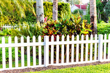 White Beach Wooden Wood Architecture Picket Fence Of House In Front Porch Yard Garden With Green Landscaping Trees Vacation Cottage Home Closeup