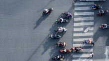 Top View Aerial Photo Of Motorcycle Driving Pass Pedestrian Crosswalk In Traffic Road With Light And Shadow Silhouette