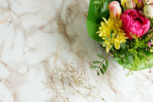 A Bright Bouquet Of Flowers On A Marble Table