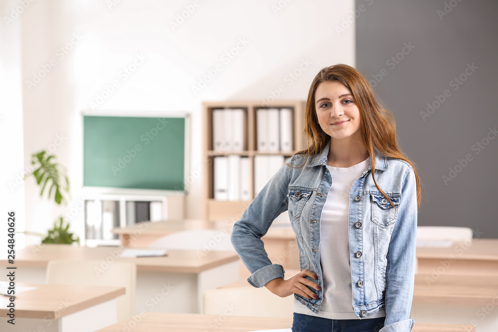 Cute schoolgirl in classroom