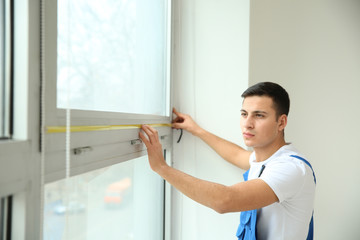 Sticker - Young worker taking measurements of window in flat