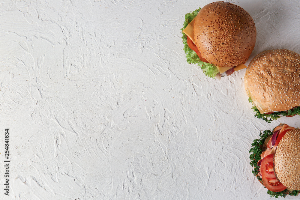 Tasty burgers on white background