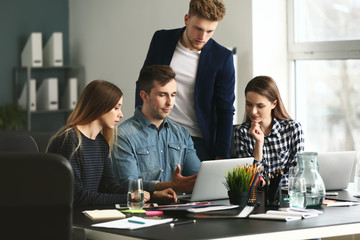 Wall Mural - Young IT specialists working in modern office