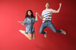 © Pixel-Shot - Happy jumping couple against color background