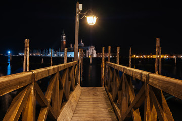 Wall Mural - Venice canal with historical buildings and gondolas at night. Italy.