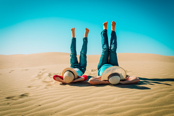 mother and son relax having fun in sand dunes