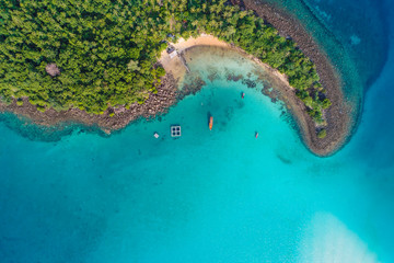 Aerial view of idyllic tranquil sea island deep blue turquoise water