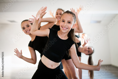 Naklejki taniec group-of-fit-happy-children-exercising-dancing-and-ballet-in-studio-together