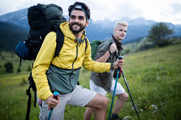 Two man traveling in a mountains staying on footpath relaxing and enjoying the wiew