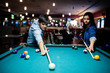 © AS Photo Family - Stylish asian couple wear on jeans playing pool billiard on bar.