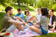 © Syda Productions - friendship, leisure and summer concept - group of happy friends eating watermelon at picnic in park