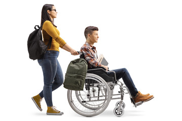 Canvas Print - Female student pushing a male student in a wheelchair