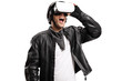 © Ljupco Smokovski - Man in a leather jacket watching on a VR headset
