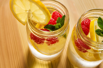 Wall Mural - soda with lemon, berries and mint on wooden table