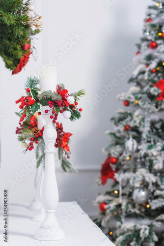 Red And Silver Round Toys Glowing Garland Christmas Tree Decorated With Poinsettia Flowers White Tinsel Of Feathers Candles Decorated With Branches Of Pine Needles Christmas Wreath On The Wall Buy This
